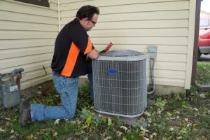 Technician performing HVAC tune-up in East Brunswick, NJ home