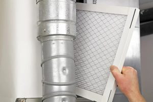technician inspecting a clogged hvac filter in Belleville, NJ